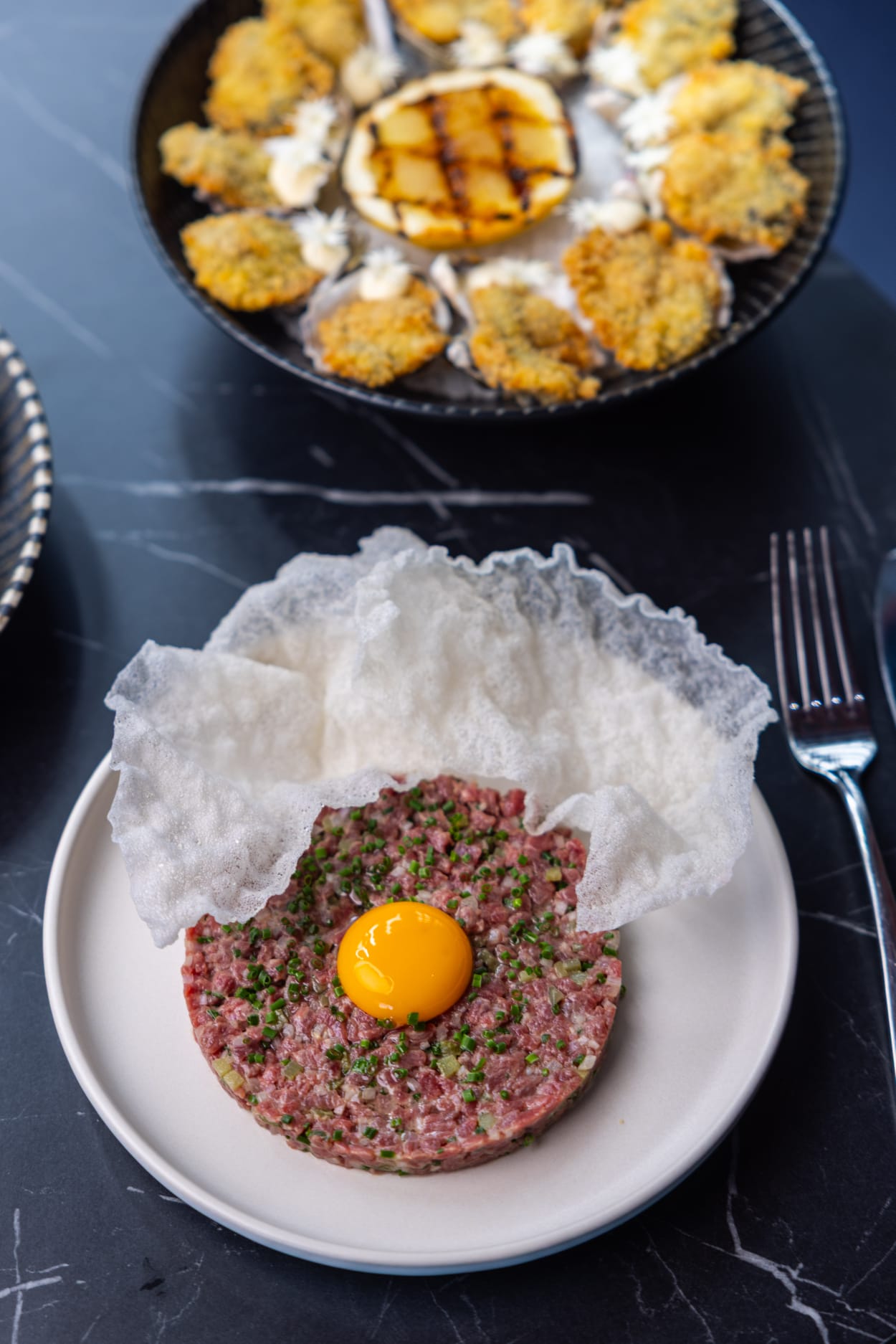 Beef tartare with egg yolk and crisp tuile